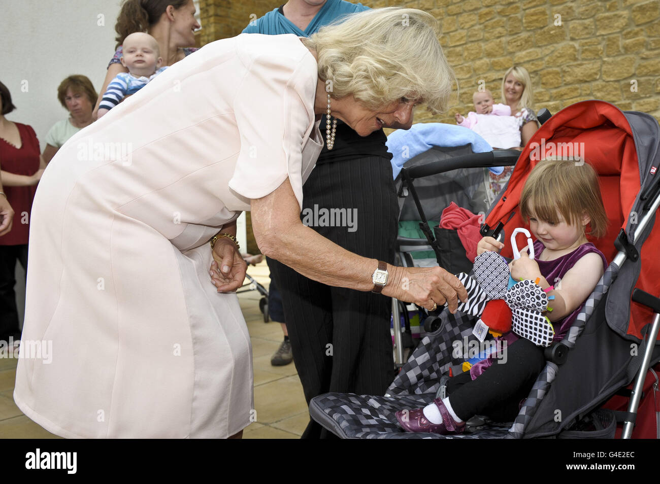 The Duchess of Cornwall talks to Evie-K Baker, aged 20 months, from Willand during her visit to the Culm Valley Integrated Centre for Health, Cullompton, Devon. Stock Photo