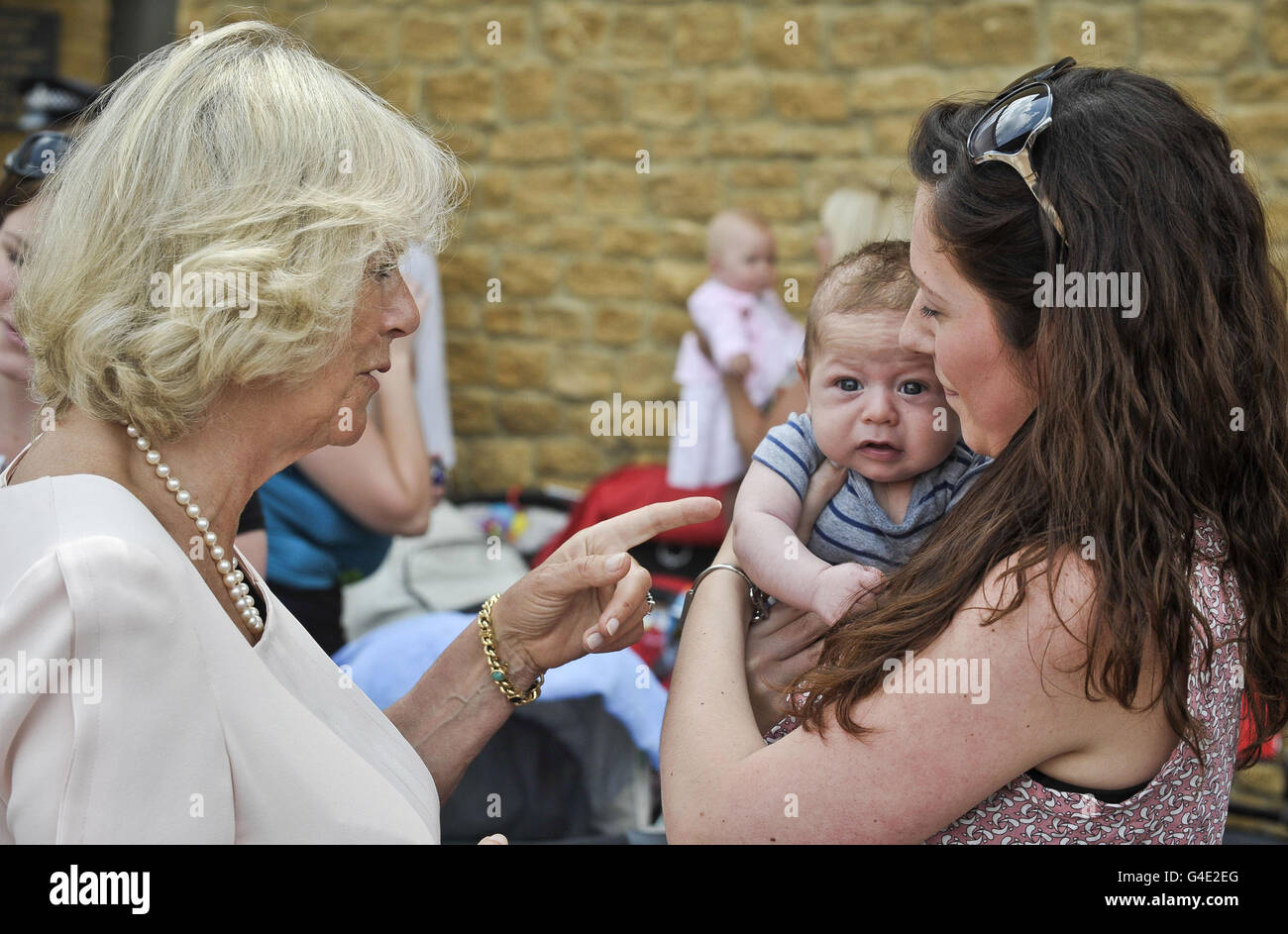 The Duchess of Cornwall talks to twelve-week-old Jacob and his mum Leanne Kingston, from Cullompton during her visit to the Culm Valley Integrated Centre for Health, Cullompton, Devon. Stock Photo