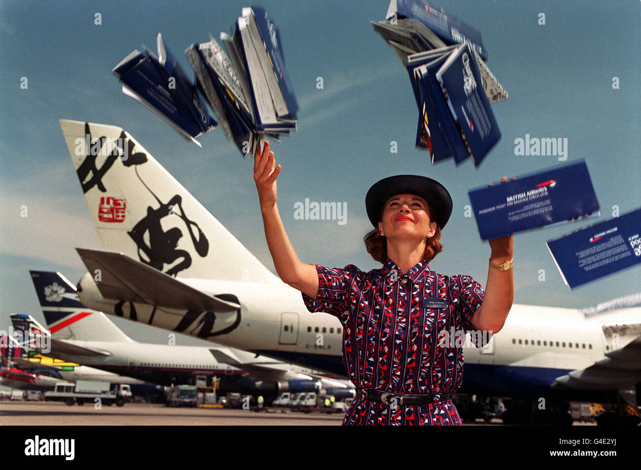 STRICT EMBARGO: NOT FOR PUBLICATION OR BROADCAST BEFORE 1730 BST, FRIDAY AUGUST 7, 1998. Paula Coxall, a BA air stewardess, demonstrates how British Airways are throwing away prices on their air fares, at Heathrow Airport today (Friday). A BA booking bonanza is expected tomorrow (Sat) with more than two million bargain seats for sale, with savings of up to 531. The offer lasts just over the weekend, with cut-price flights available to more than 80 destinations. See PA Story TRAVEL BA. Photo by Neil Munns. Stock Photo