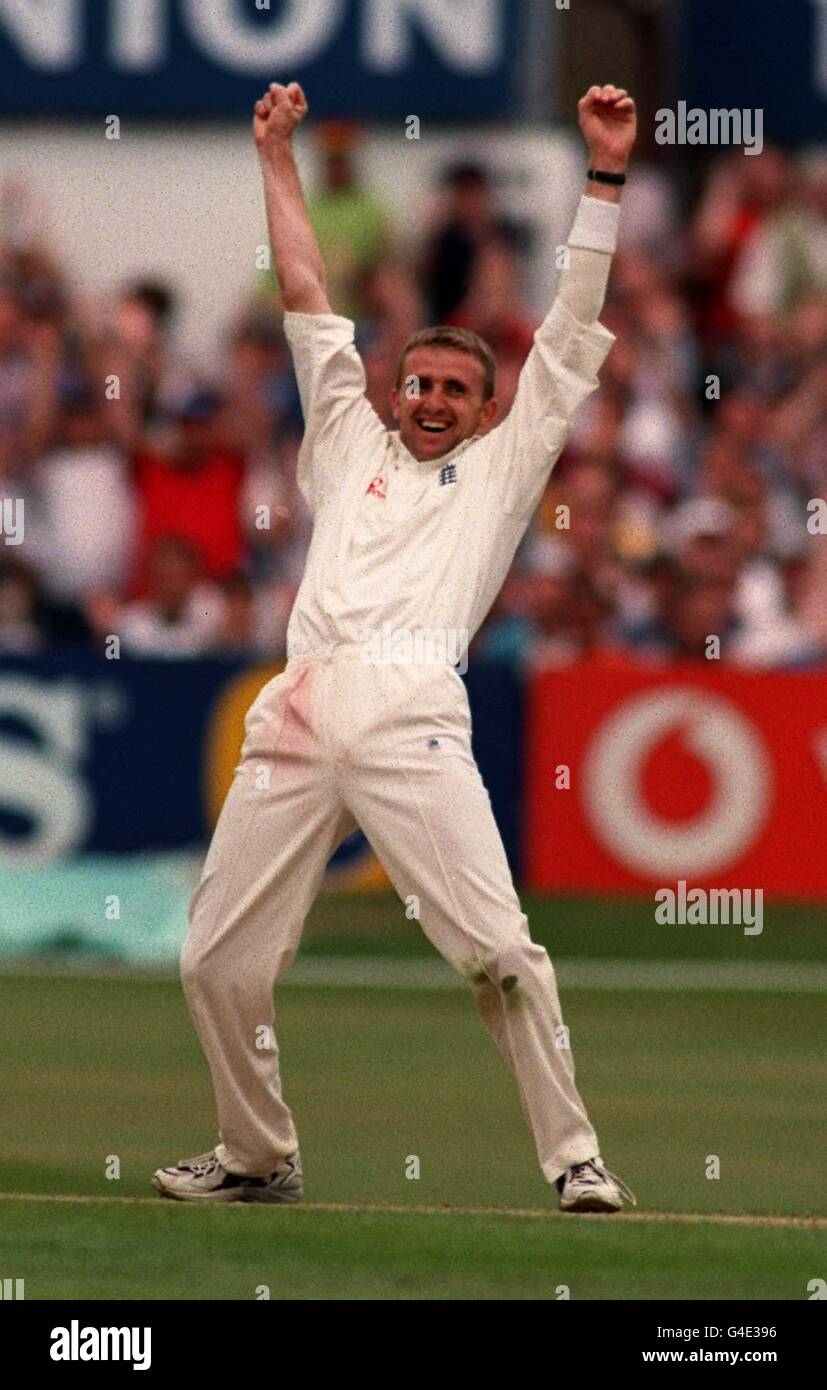 England's Dominic Cork celebrates the wicket of South African paceman