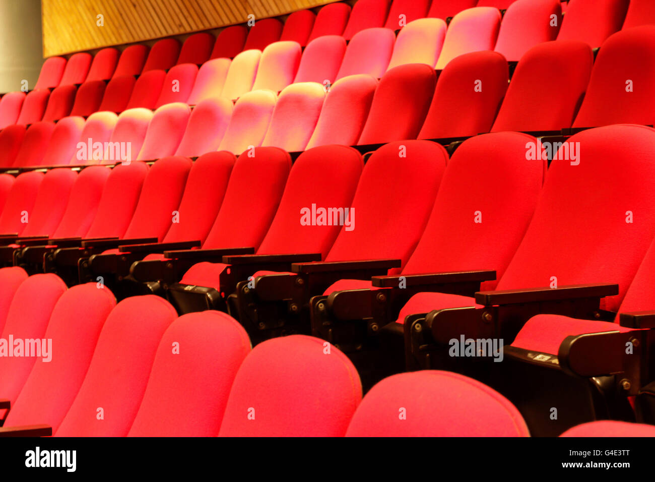Photograph of some empty red theater seats Stock Photo