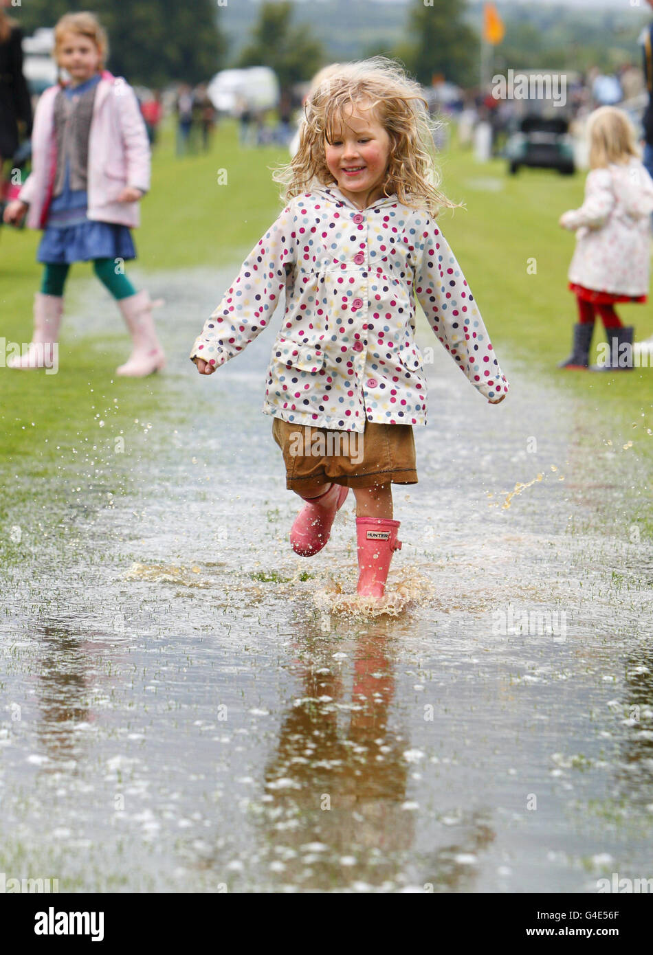 Ruby Moorhouse, 4, enjoys a puddle created by a sudden downpour before ...
