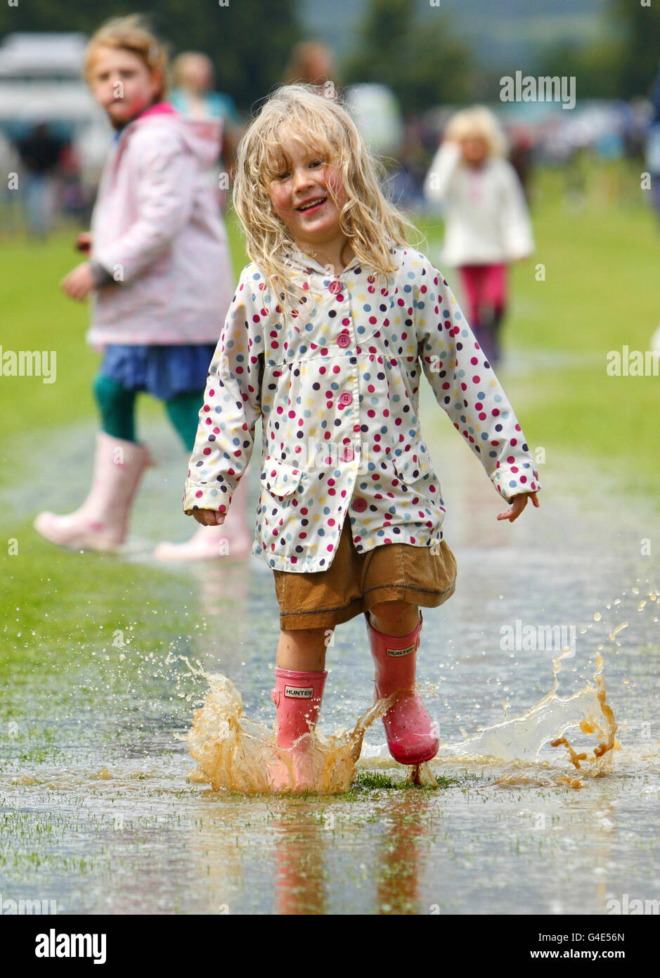 Ruby Moorhouse 4, enjoys a puddle created by a sudden downpour before the Veuve Clicquot Gold Cup Polo final at Cowdray, West Sussex. Stock Photo