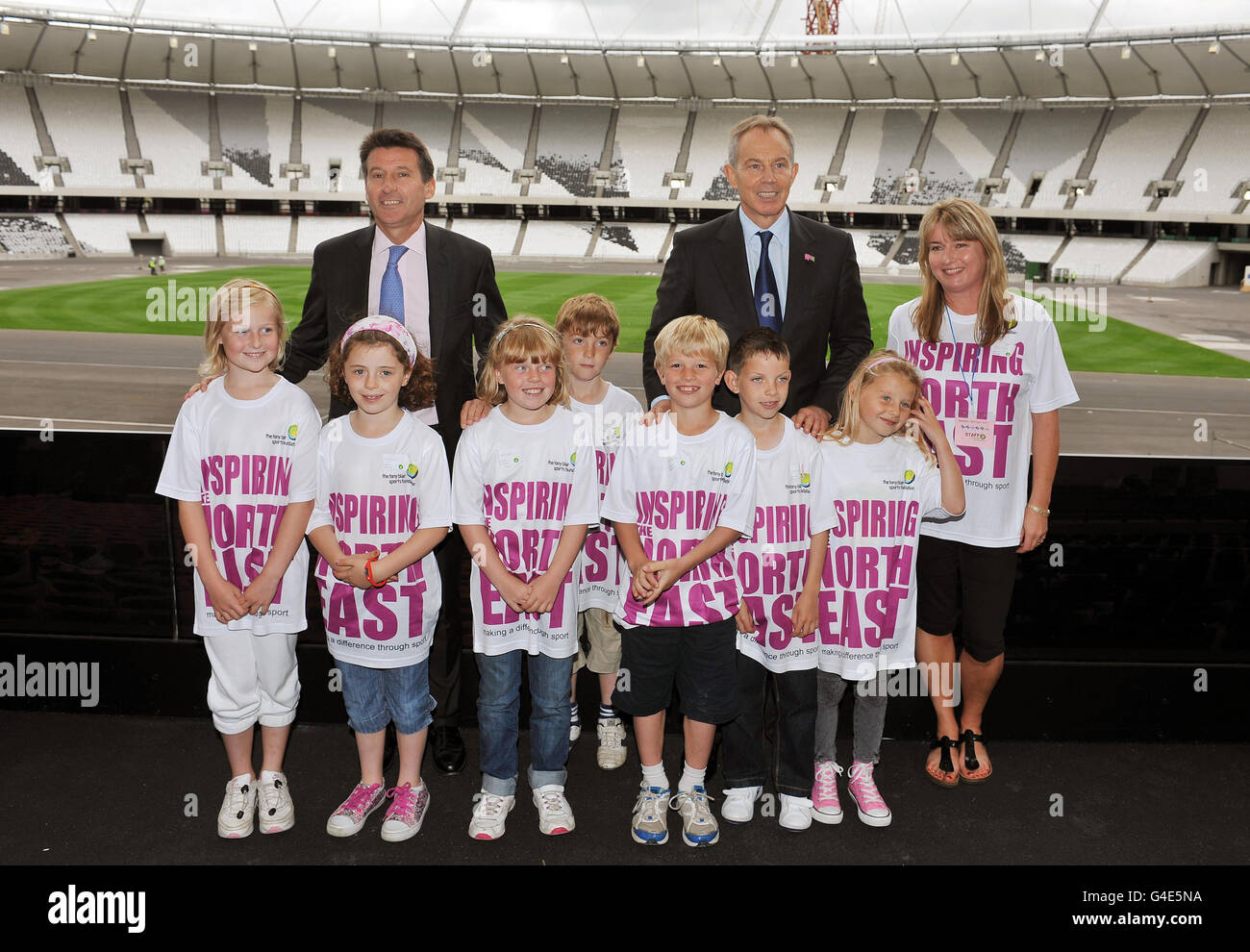 Tony Blair, the former Prime Minister pictured with London 2012 Organising Committee chairman Sebastian Coe and Schoolchildren from the north east of England, who are competition winners in the Tony Blair Sports Foundation. The children got the chance to see the nearly completed London Olympic Stadium in Stratford east London, this afternoon. Stock Photo