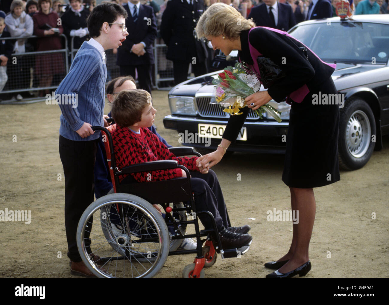The Princess of Wales meeting a wheelchair bound child at the opening a