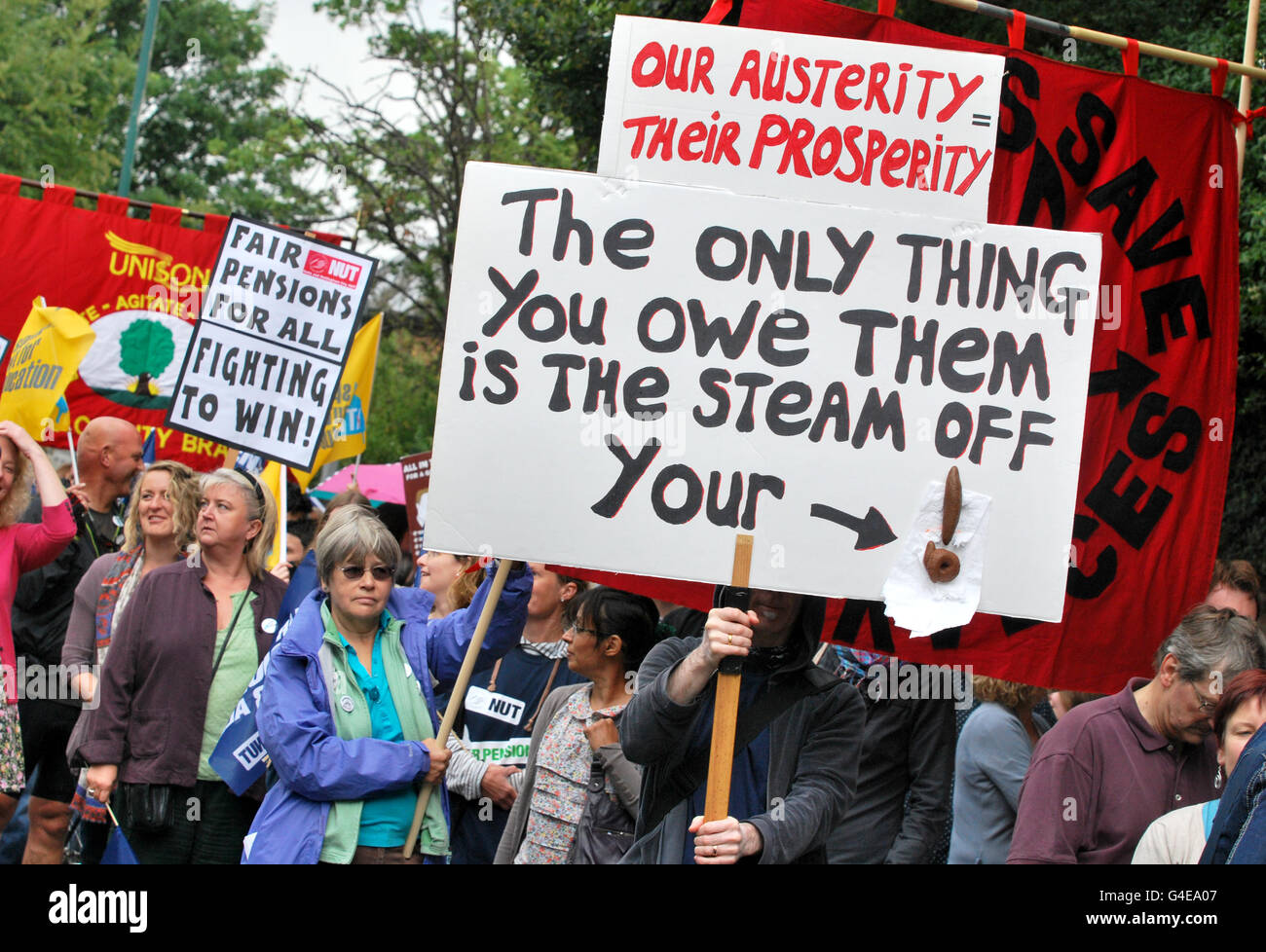 Protesters hold placards in Nottingham city centre during a one day national strike against pension changes and funding cuts to the public sector. Stock Photo