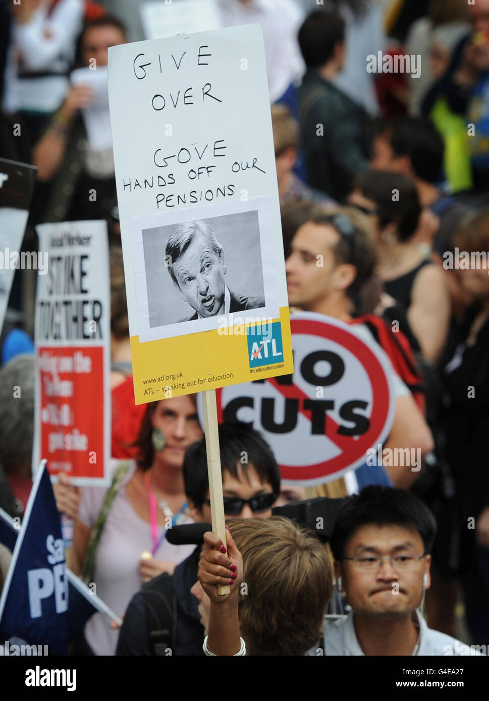 Demonstrators in central London take part in a protest through the capital against the UK government's plans for pension reform. Stock Photo