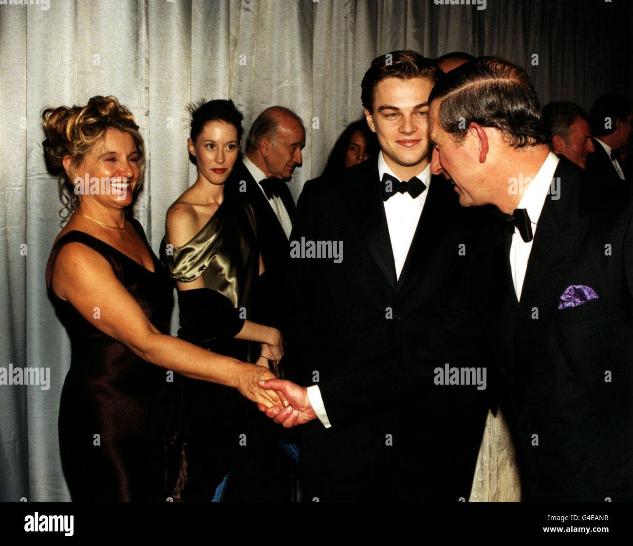 PRINCE CHARLES MEETS LEONARDO DICAPRIO AND HIS MOTHER IRMELIN INDENBIRKEN AT THE ROYAL MOVIE PREMIERE OF 'TITANIC' AT THE ODEON IN LEICESTER SQUARE, LONDON. Stock Photo