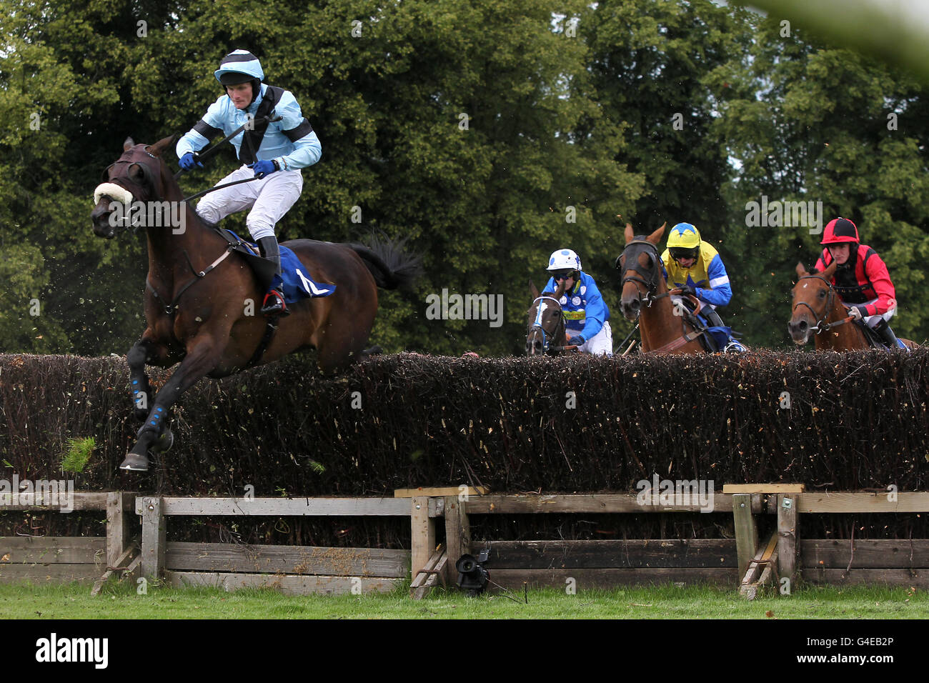 Charlie Poste Racing Jockey Charlie Poste on Calusa Catrina (left) jumps ahead of the rest ...