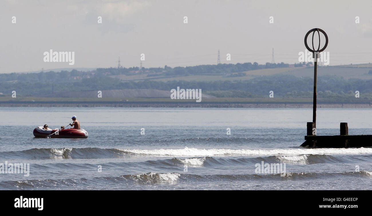 Members of the public enjoy the hot weather at Portobello beach near