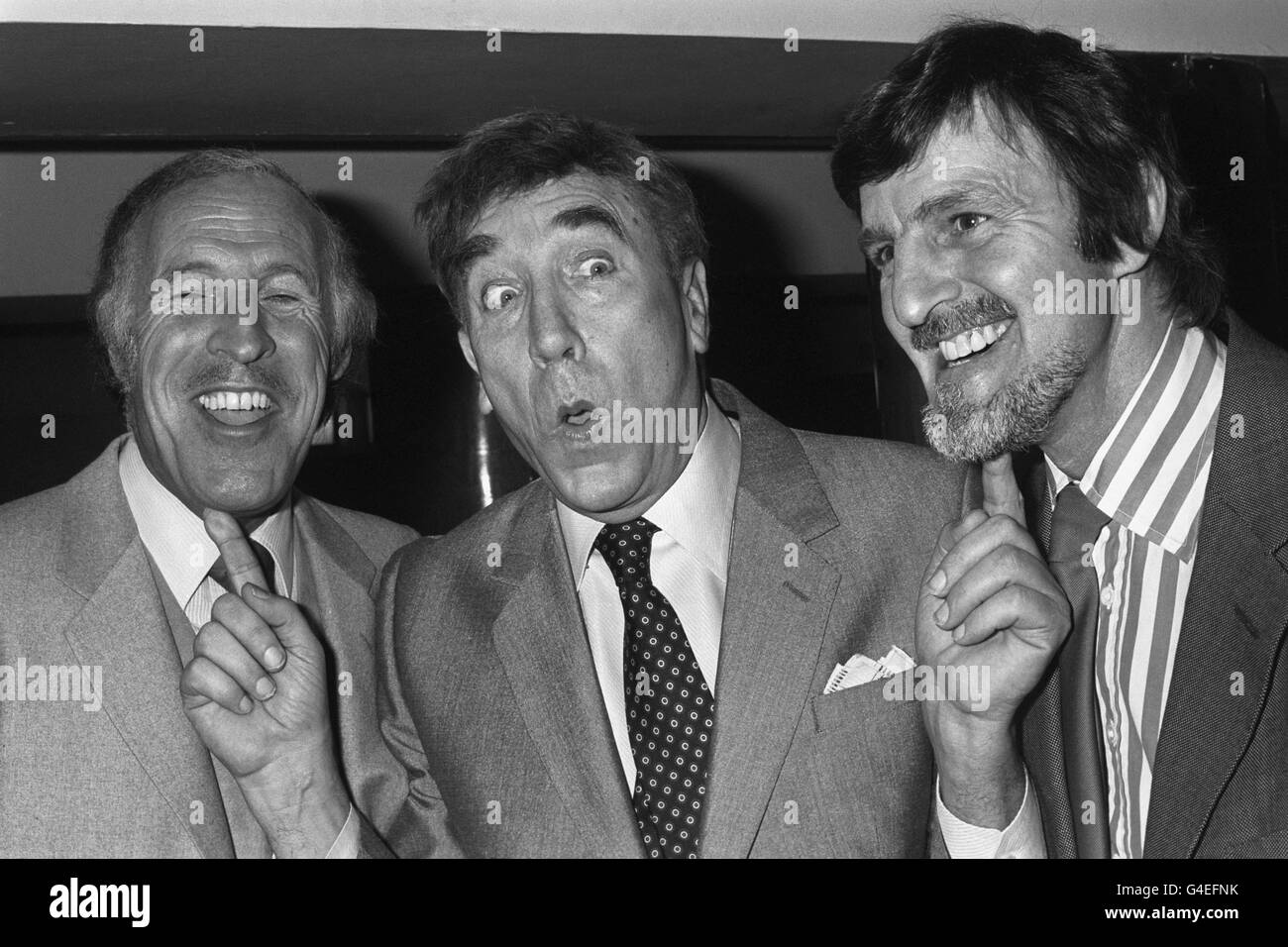 Entertainer Frankie Howard (c) puts his fingers on two of the most famous chins on television, Bruce Forsyth (l) and Jimmy Hill (r), at the Variety Club Lunch celebrating his 35 years in show business. Stock Photo