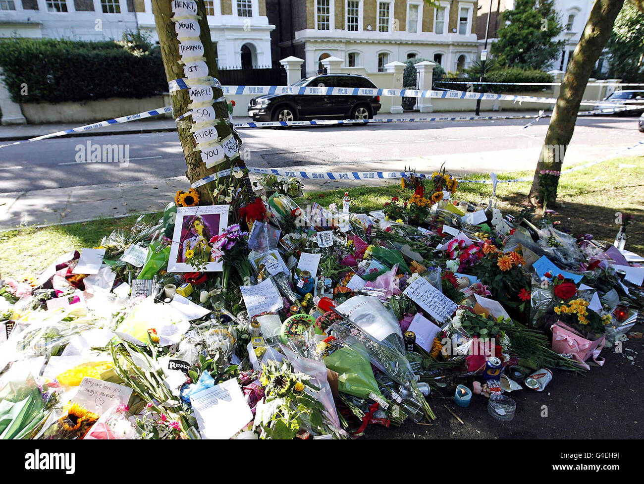 EDITORS NOTE CONTENT. Flowers, tributes and song lyrics are left outside the north London home of Amy Winehouse where she was found dead on Saturday. Stock Photo