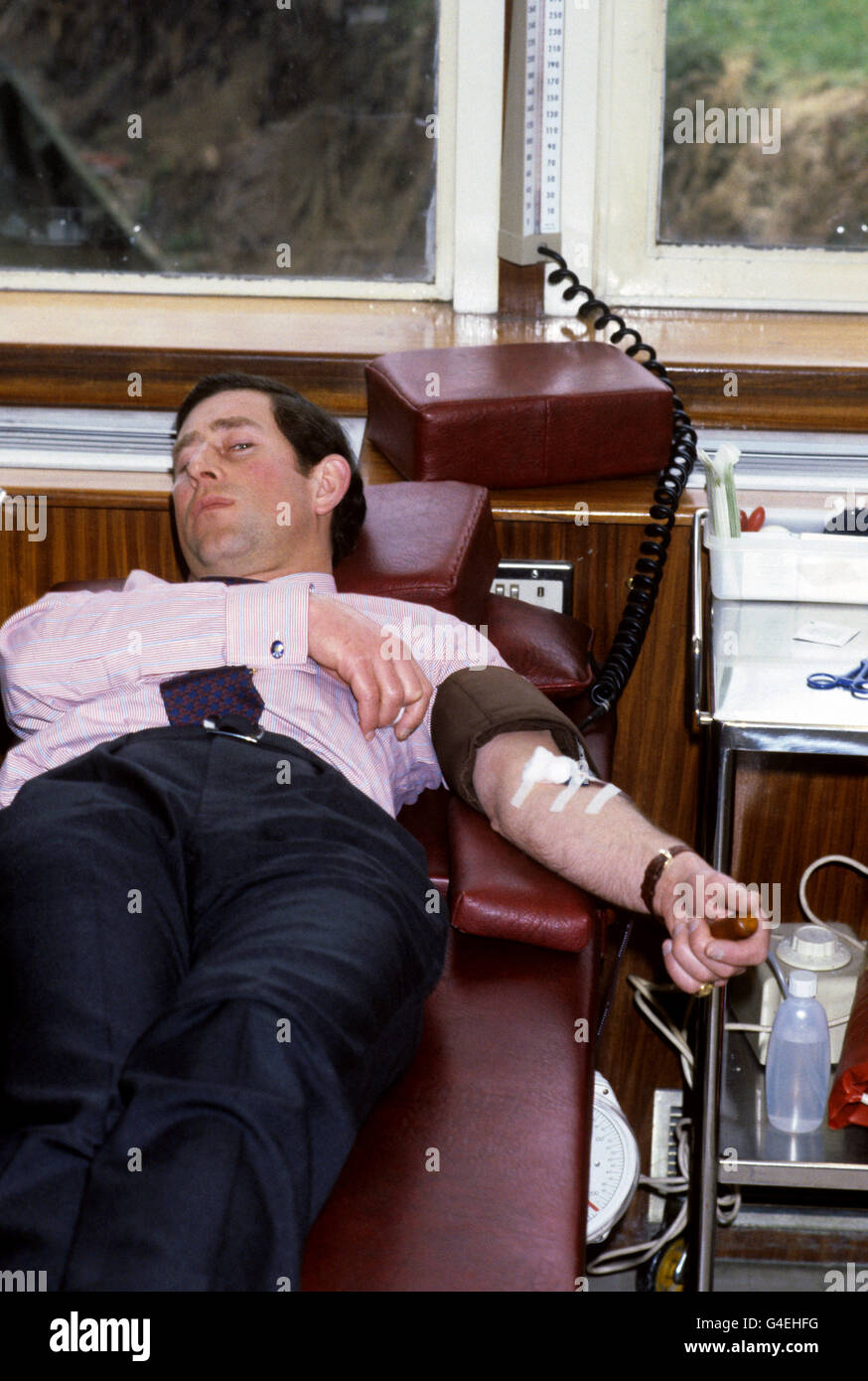 The Prince of Wales giving a pint of blood for the first time, at the North London Blood Transfusion Centre Stock Photo