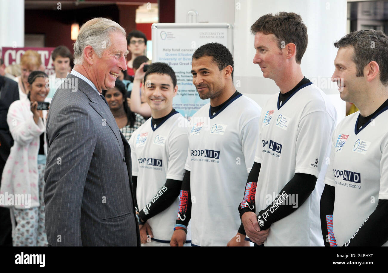 Britain's Prince Charles meets rugby player Jason Robinson (third right) and (left to right) Chris Armstrong, Sgt Rob Guyton and Sgt Mike Potts at Birmingham's Queen Elizabeth Hospital, after they completed the Bastion to Birmingham Challenge. The event saw 20 people running and cycling the 3580 miles on treadmills and bikes in 48 hours, raising an estimated 10,000 for forces charities. Stock Photo