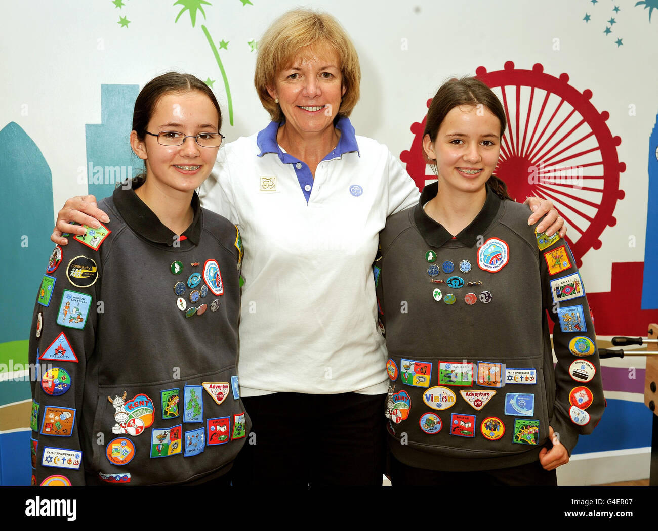 Bethany (left) and Abby Williams twin sisters, 15, from Gravesend in Kent, with Chief Guide for the UK Gill Slocombe (centre) show off their 45 Badges and Awards for Guiding, at the Girl Guides UK Headquarters in Westminster, London. Stock Photo