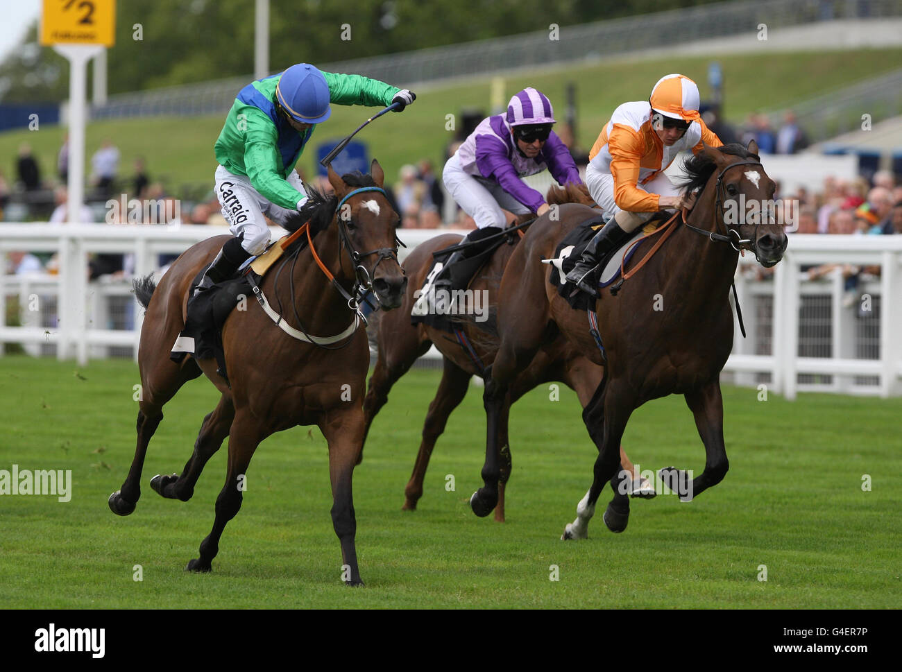 Jockey Kieran Fallon (blue cap) rides Caledonian Spring wins beating Mehdi riden by Shane Kelly into second place during The Saco Serviced Apartments E.B.F Maiden Stakes during the Betfair Weekend at Ascot Racecourse, Ascot. Stock Photo