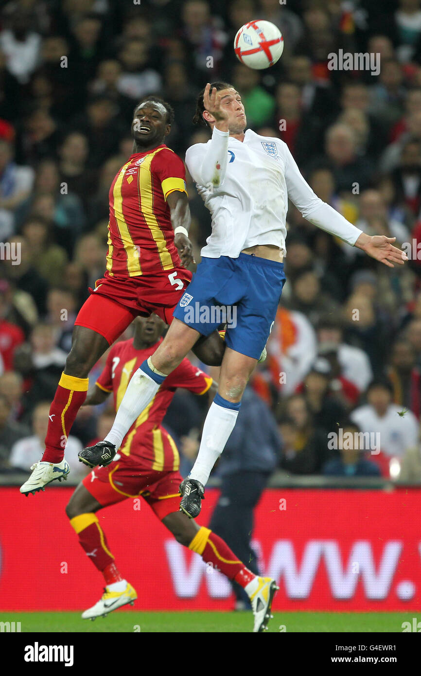 Soccer - International Friendly - England v Ghana - Wembley Stadium. Ghana's John Mensah (left and England's Andy Carroll in action Stock Photo