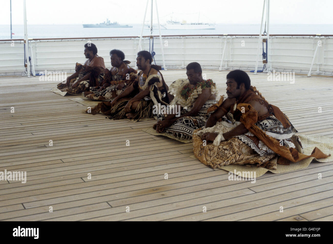 Fijian chiefs perform the traditional ceremonies of 'Cavuikeleke' on board the Royal Yacht Britannia watched by Queen Elizabeth II and the Duke of Edinburgh Stock Photo