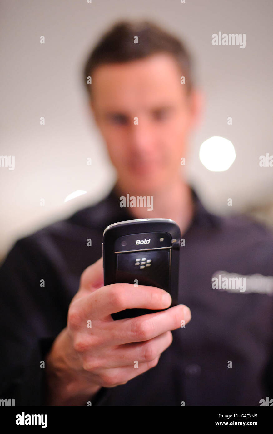 A demonstrator shows off a new handset at the global launch of Research In Motion's BlackBerry 7 smartphones, at the Soho Hotel in London. Stock Photo