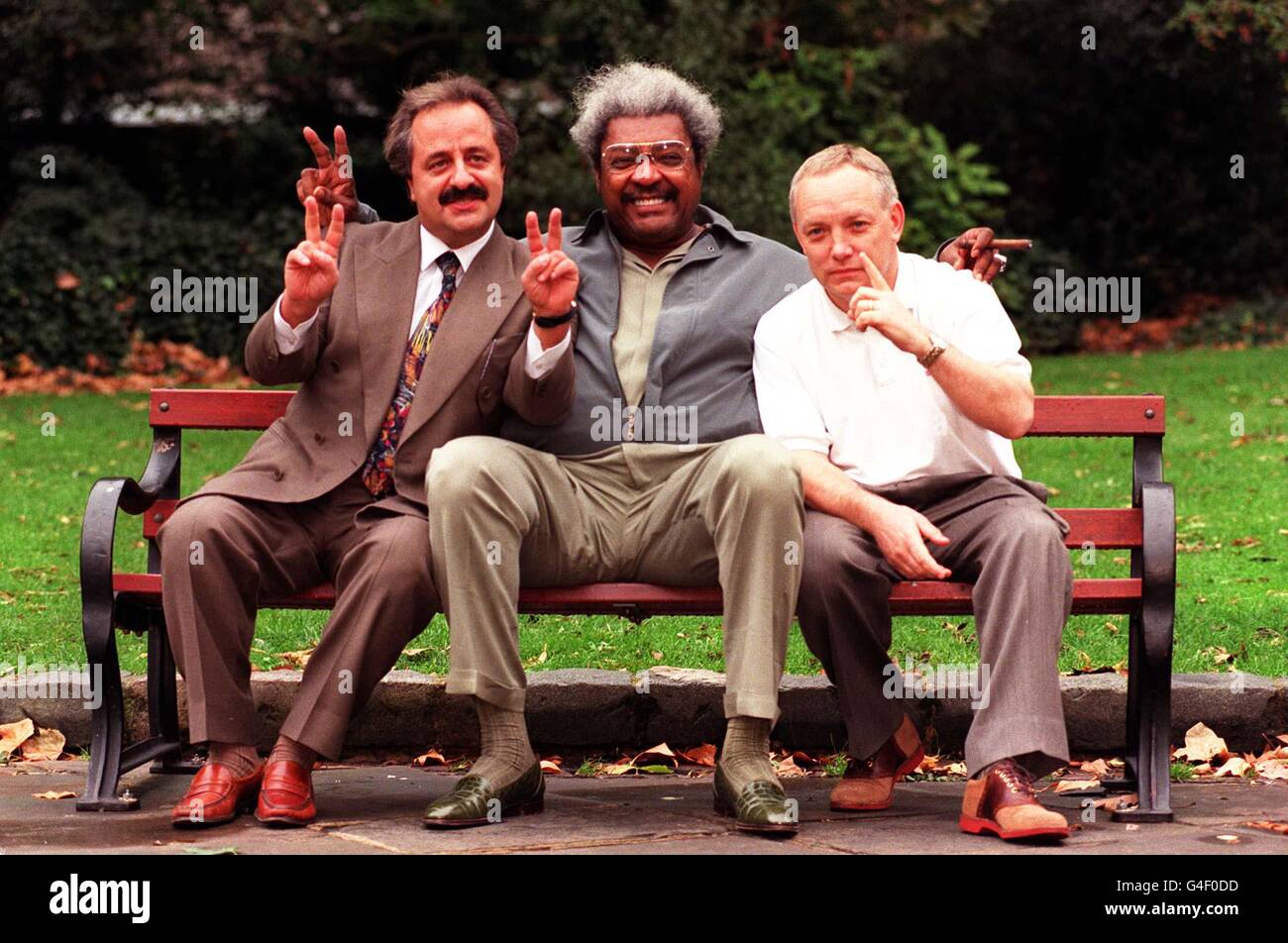 Evander Holyfield's promoter Don King (centre) flanked by WBC champion Lennox Lewis's promoter Panos Eliades (right) and his manager Frank Maloney during a photocall in London this afternoon (Tuesday), regarding the forthcoming Lewis v Holyfield World Title fight. See PA Story BOXING Lewis. Photo by Toby Melville/PA Stock Photo