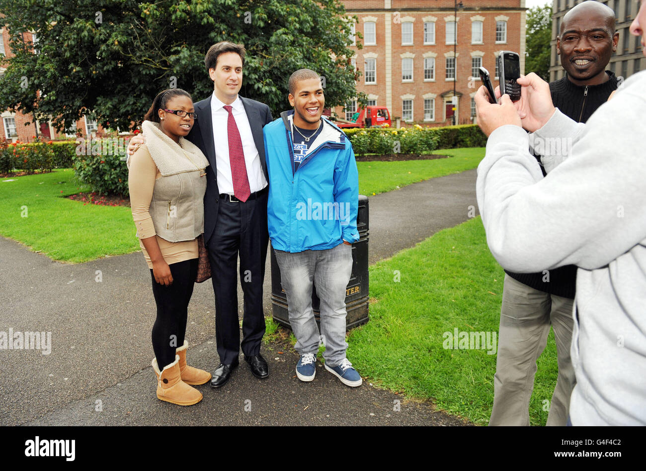 Labour leader Ed Miliband poses for Facebook pictures in St Pauls in Bristol with local community activist Narraser Gordon, 24 and college student Levi Leopard during a visit to the area following last week's disturbances. Stock Photo