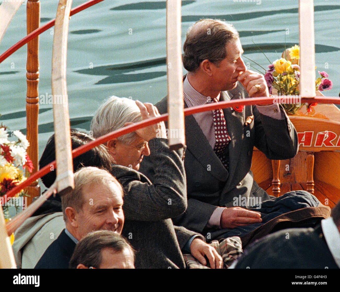 LJU02-19981102-BLED, SLOVENIA: Prince of Wales (R) and Slovenian President Milan Kucan (C), with unidentified officials sitting in a sightseeing boat, looking at the island on Lake Bled during a visit to the Slovenian Bled National Park, 02 November 1998. Prince Charles on Monday arrived in Slovenia for a two-day official visit as part of a tour of the Balkan region. PA NEWS PHOTO Stock Photo