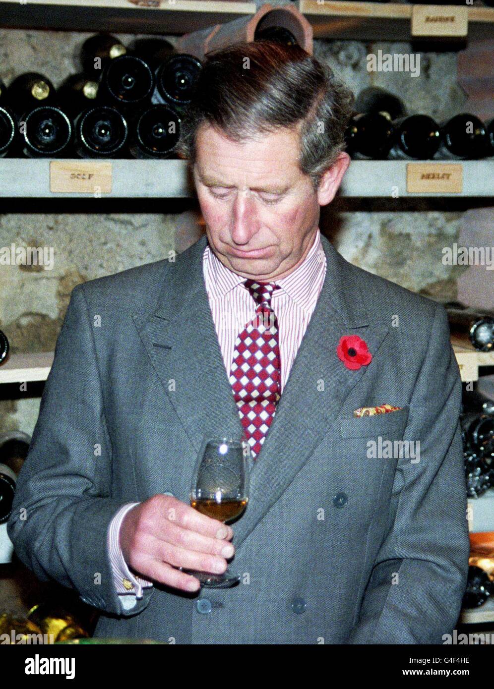 LJU10-19981102-LJUBLJANA, SLOVENIA: HRH The Prince of Wales looks down to a glass as he tastes a local wine in the wine cellar of Bled Castle, some 80 kilometers northwest of the Slovenian capital Ljubljana, during his two days official visit to Slovenia, 02 November 1998. PA NEWS PHOTO Stock Photo
