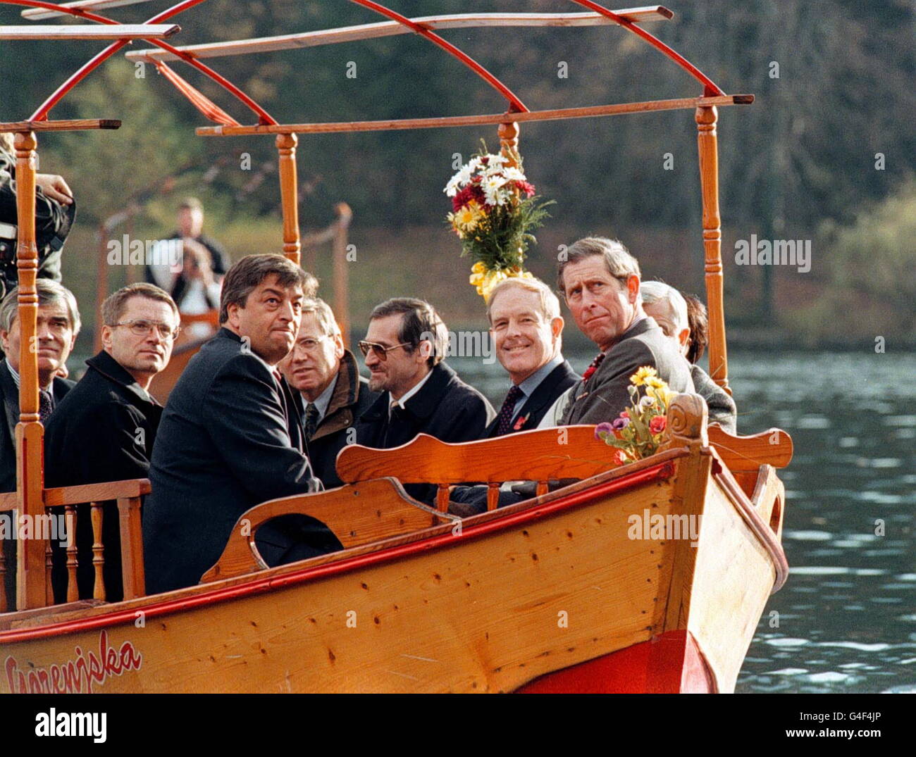 LJU01-19981102-BLED, SLOVENIA: The Prince of Wales (R), sitting in with unidentified officials on a sightseeing boat, watches the island on Lake Bled during a visit to the Slovenian Bled National Park, 02 November 1998. Prince Charles on Monday arrived in Slovenia for a two-day official visit as part of a tour of the Balkn region. PA NEWS PHOTO Stock Photo