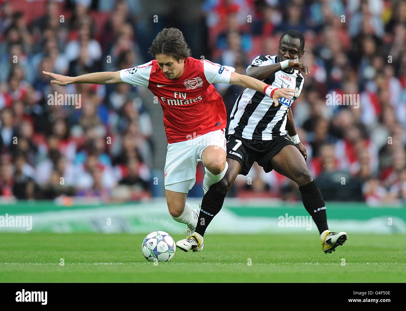 Soccer - UEFA Champions League - Play Offs - First Leg - Arsenal v Udinese - Emirates Stadium. Udinese's Emmanuel Agyemang-Badu (right) and Arsenal's Tomas Rosicky battle for the ball Stock Photo