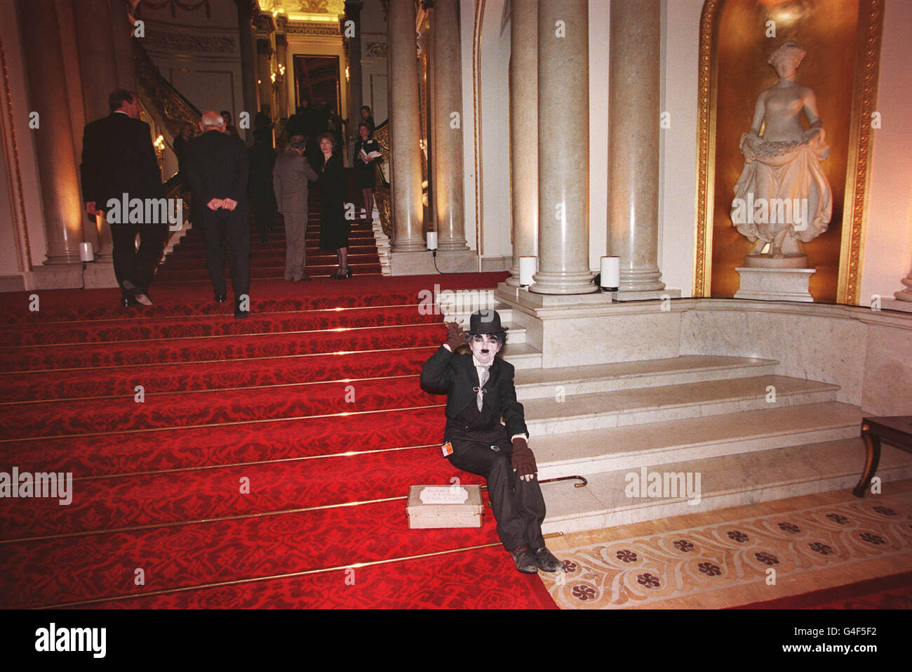 An entertainer waits inside Buckingham Palace, the official London residence of Queen Elizabeth II, where she was holding a reception Friday November 13, 1998 for her oldest son, the Prince of Wales, on the eve of his 50th birthday. Stock Photo
