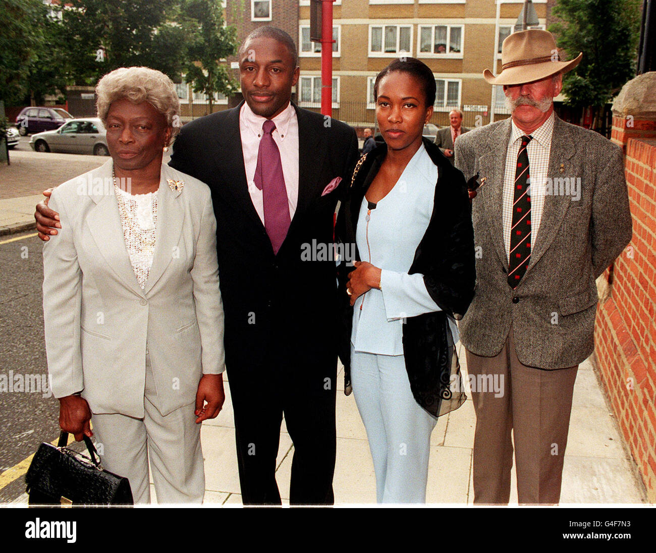 Former football star John Fashanu arrives at the inquest in London today (Weds) into the death of his brother Justin, the ex-Nottingham Forest and Norwich striker who was found hanging from a rafter in a derelict garage in east London on May 2. Pictured with Mr Fashanu is his wife Melissa and two unidentified family members. Photo by Neil Munns. See PA Story INQUEST Fashanu. Stock Photo