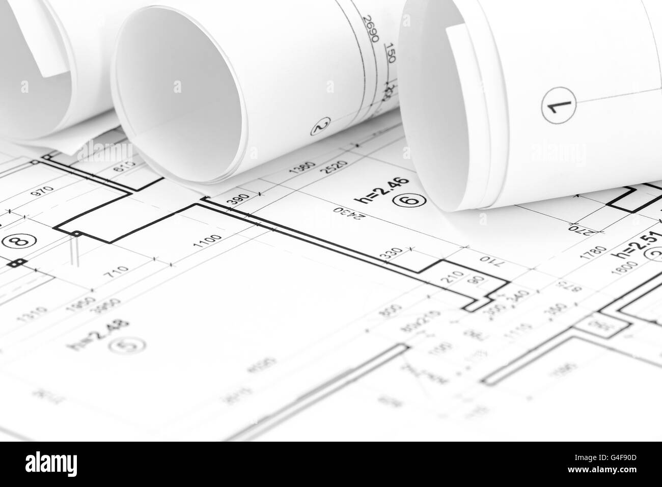 architect workspace with rolled floor plans and blueprints Stock Photo