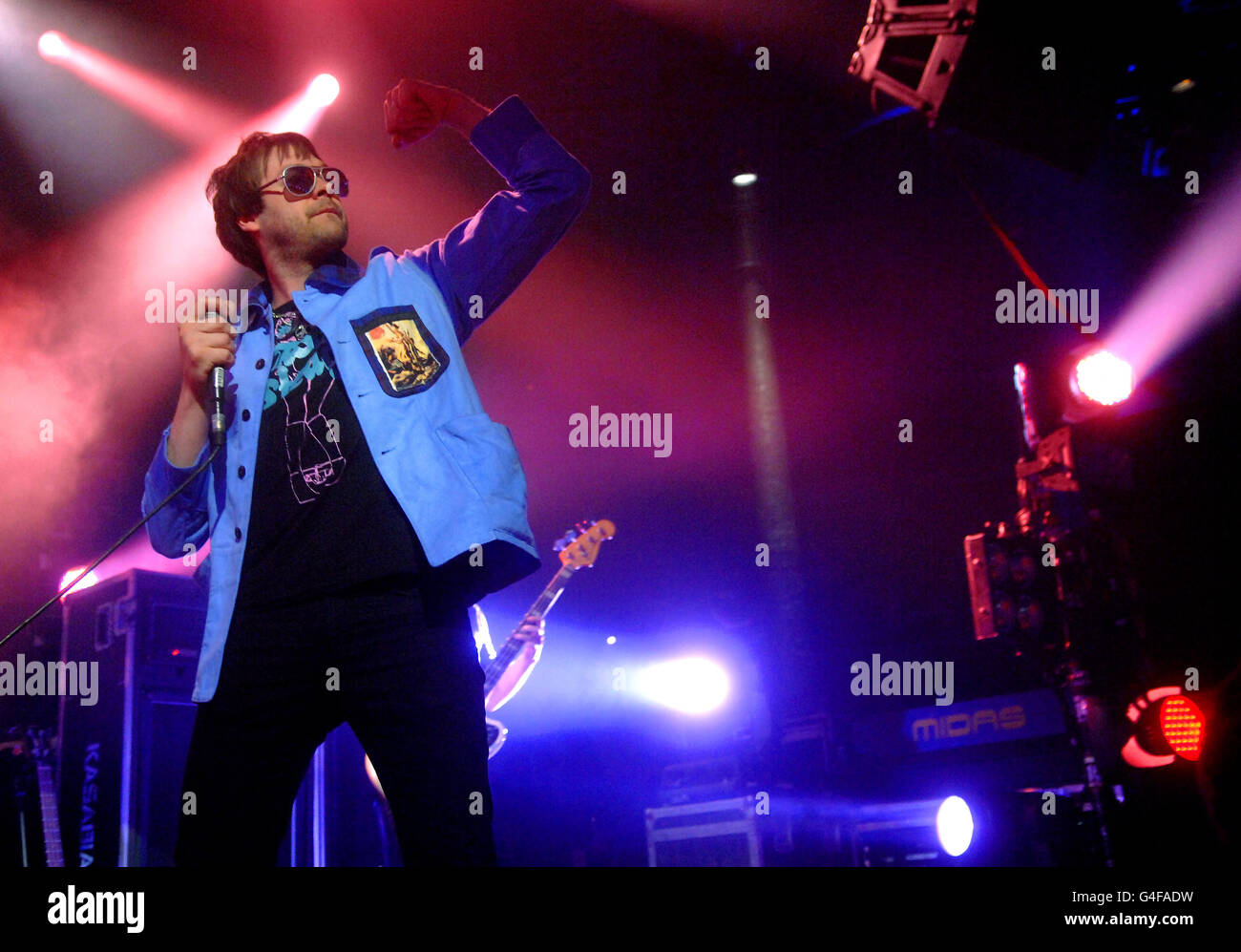 Tom Meighan of Kasabian performs on stage at the Roundhouse in north London, as part of the iTunes Festival. Stock Photo