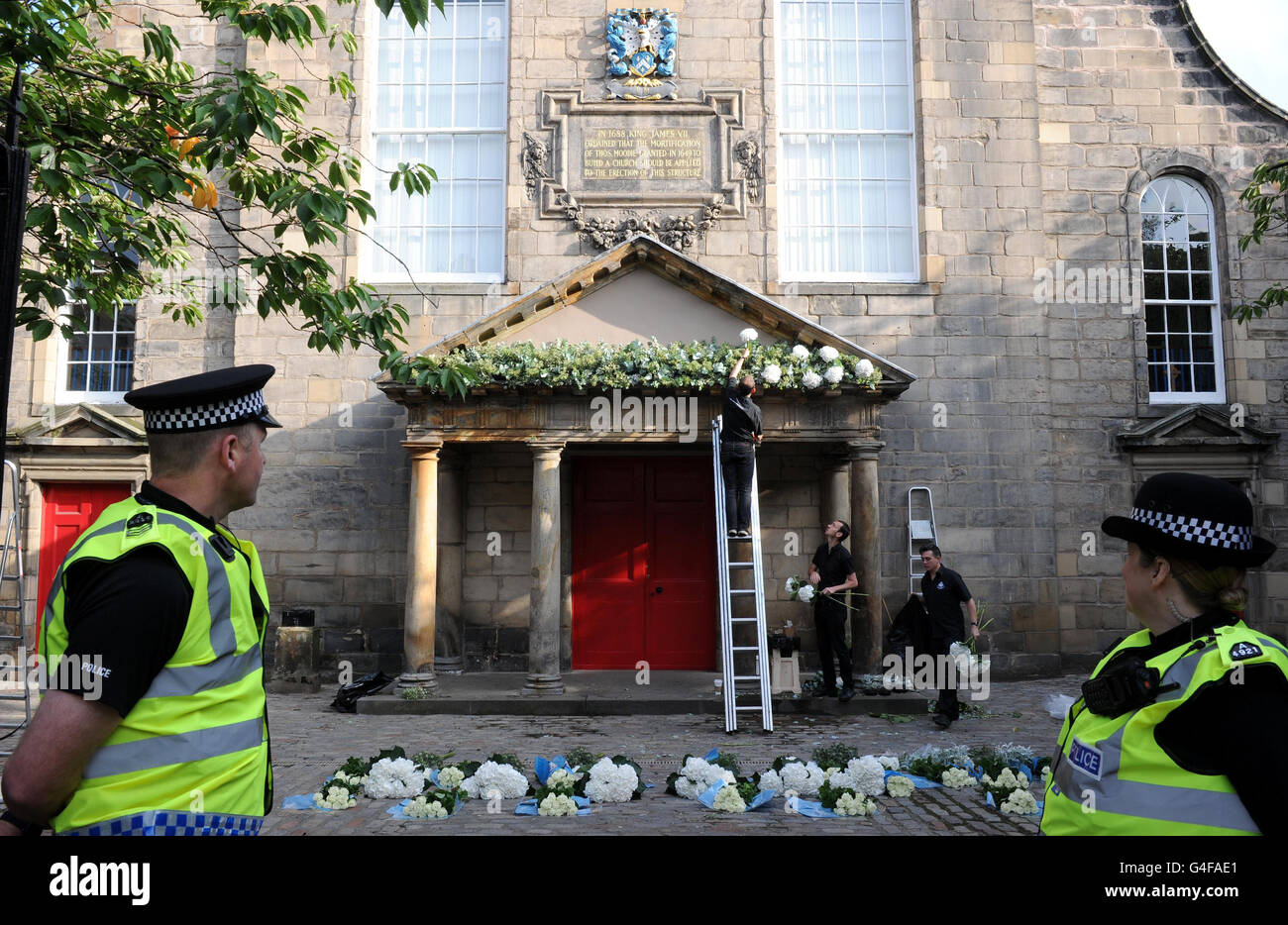 Flowers are placed at the Canongate Kirk, in Edinburgh, as final preparations continue ahead of the wedding of Zara Phillips and Mike Tindall. Stock Photo