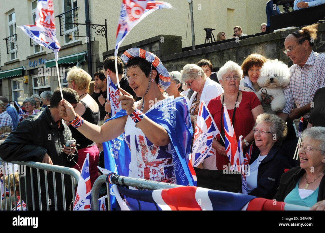 Royal fan Elaine Russell from Glasgow joins crowds at the Canongate Kirk, in Edinburgh, as final preparations continue ahead of the wedding of Zara Phillips and Mike Tindall. Stock Photo