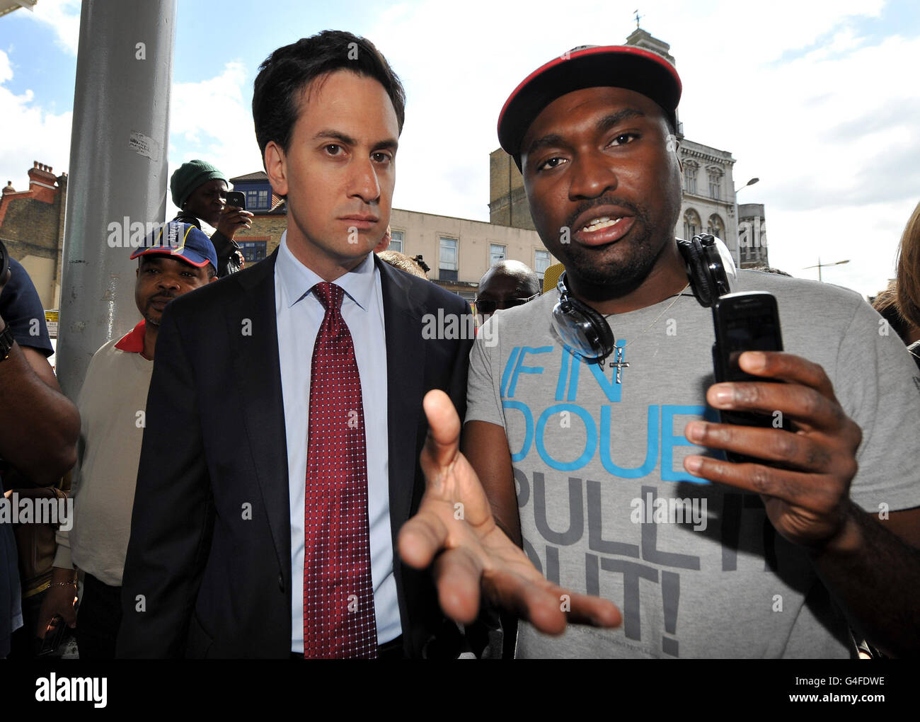 Labour leader Ed Miliband (left) speaks with Stafford Blake from Peckham during a visit to Peckham in south London, where rioting took place last night. Stock Photo