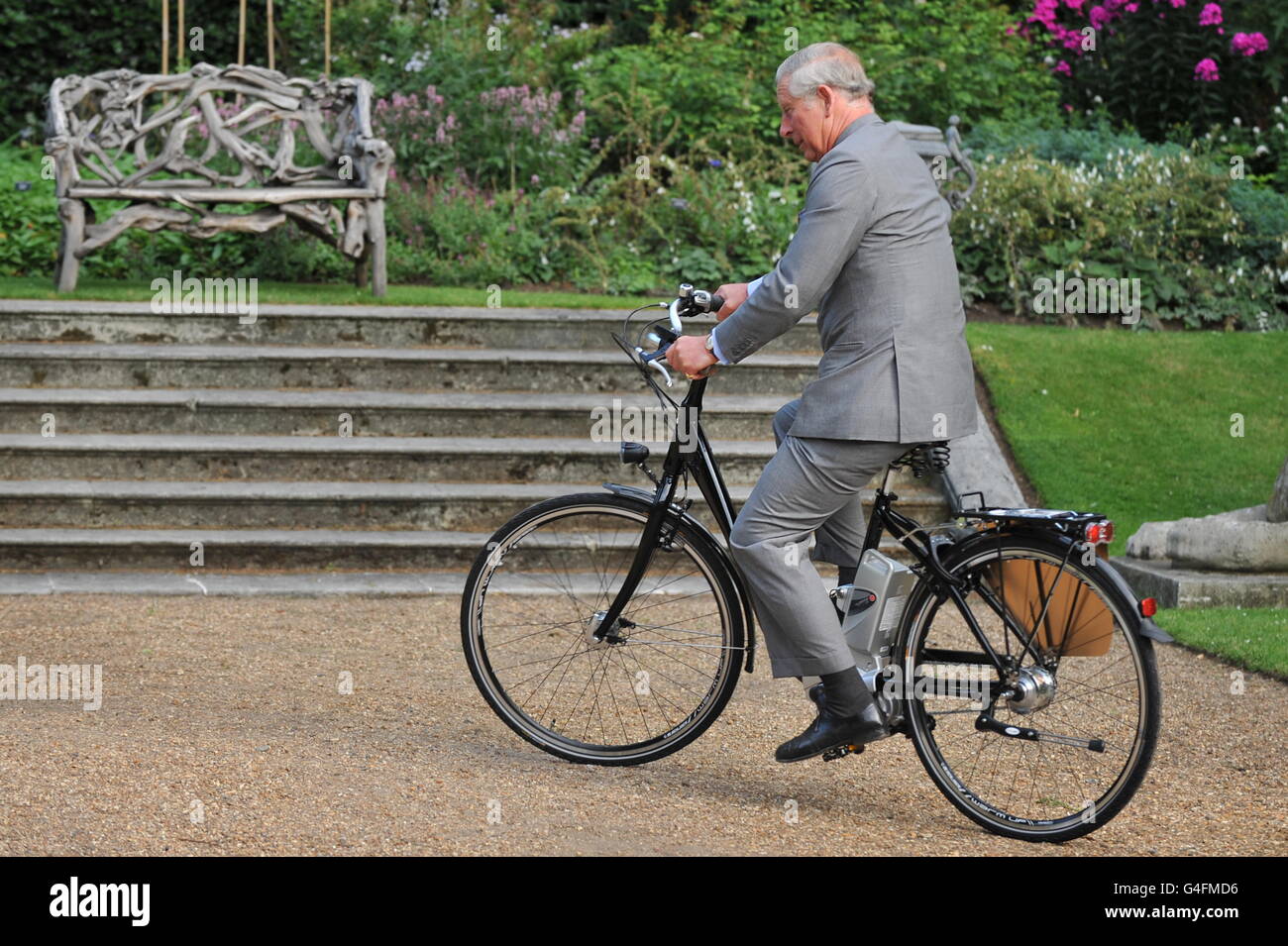 The Prince of Wales rides an electric bicycle during the Start Garden Exhibition and Pop-Up Restaurant at Clarence House in central London. PRESS ASSOCIATION Photo. Picture date: Wednesday July 27, 2011. See PA story ROYAL Charles. Photo credit should read: Ben Stansall/PA Wire Stock Photo