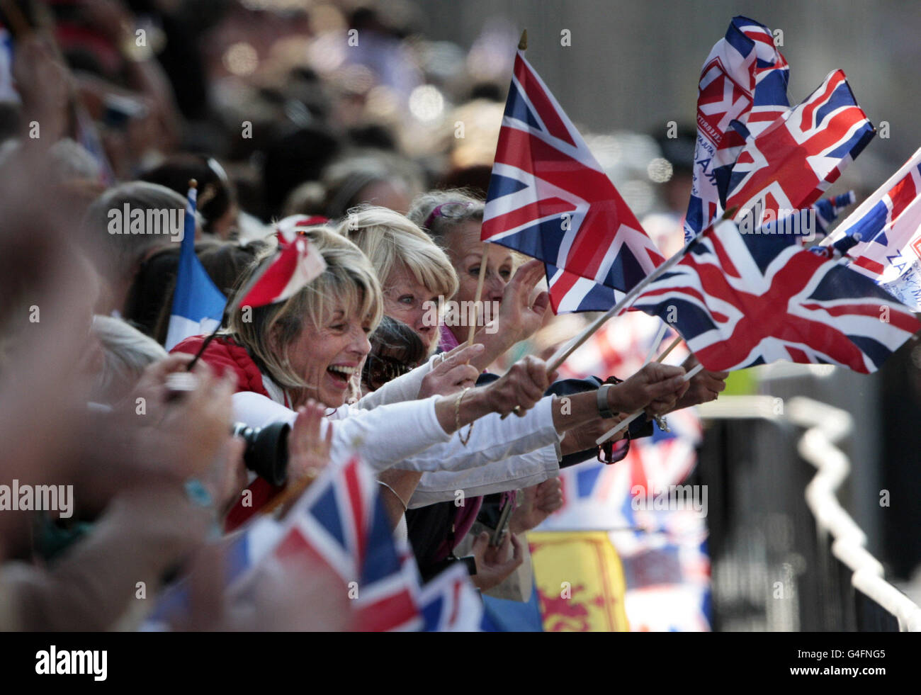 Crowds celebrate along the Royal Mile in Edinburgh after the wedding of Zara Phillips and Mike Tindall. Stock Photo