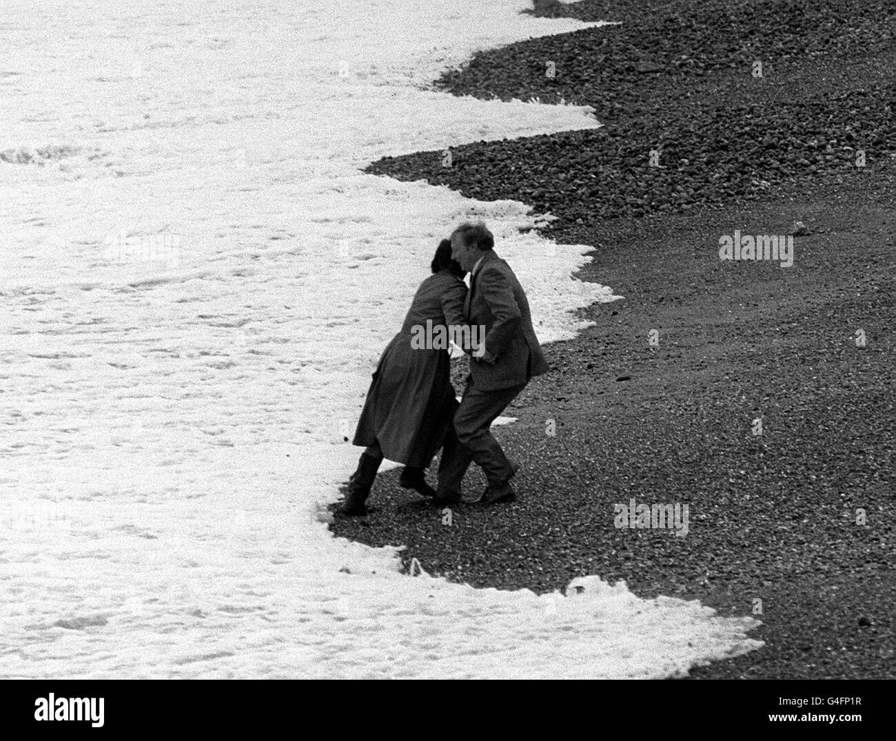 PA NEWS PHOTO 2/10/83 NEIL KINNOCK AND HIS WIFE FOOLING AROUND ON BRIGHTON BEACH Stock Photo