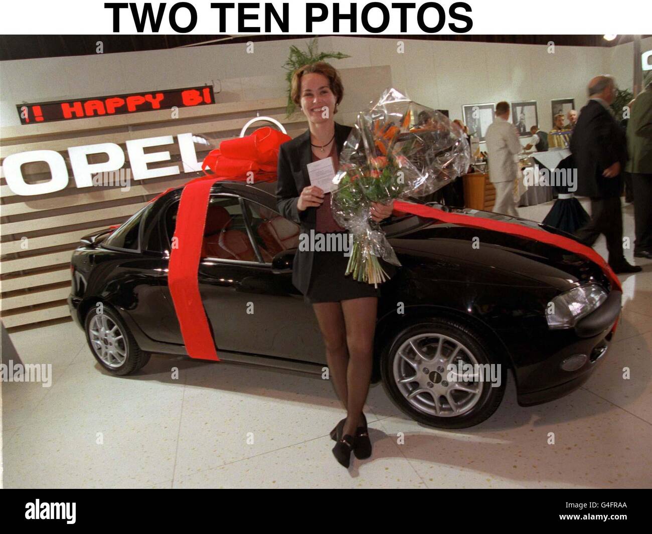 TWO TEN Photos. London 30.9.98: Top-ranked women's tennis player Martina Hingis pictured with her driver's license and her new Opel Tigra, during her birthday party today (Wednesday) at the Grand Slam Cup at the 'Olympiahalle' in Munich. This special 'MH edition' was custom-made for the star. Stock Photo