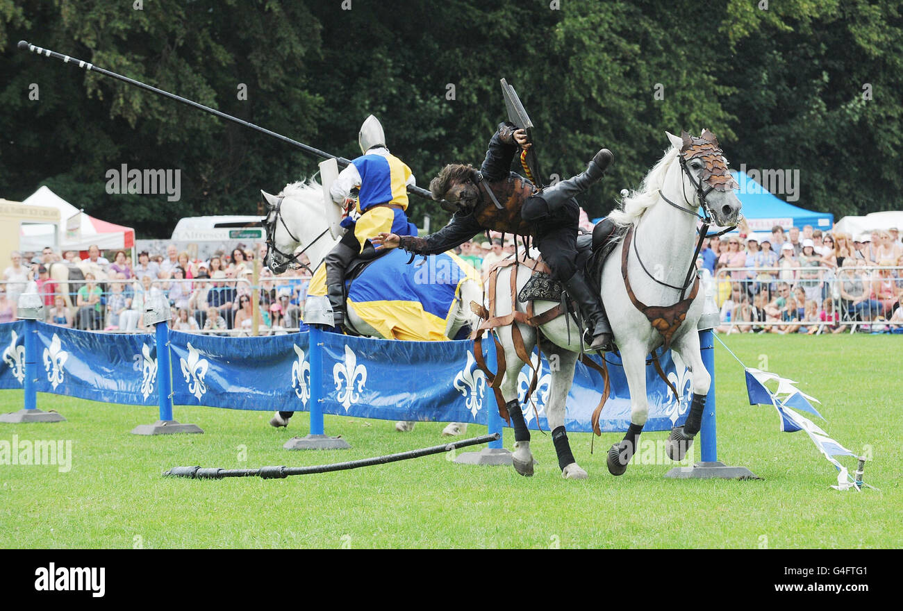 Members of the Rockin' Horse Equestrian Stunt Team shows off their jousting skills during a performance of the Orc Show which is held as part of the annual Thornton-le-Dale Country Show near Pickering, North Yorkshire. Stock Photo