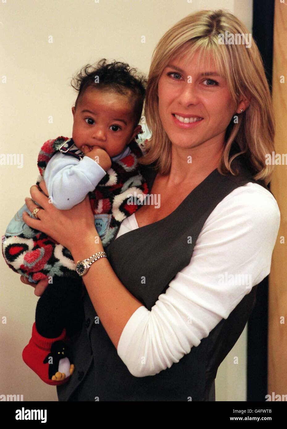 Former Olympic swimmer turned TV presenter Sharron Davies and her four-month-old daughter Grace, at the NSPCC (National Society for Prevention of Cruelty to Children) National Centre in London this morning , the mother-of-two told the launch of 'The pack to help parents not smack', she had occasionally given four-year-old Elliott a slight tap. But said four-month-old Grace was still too young to be disciplined. See PA Story SOCIAL Smack. Photo by Mathew Fearn/PA. Stock Photo