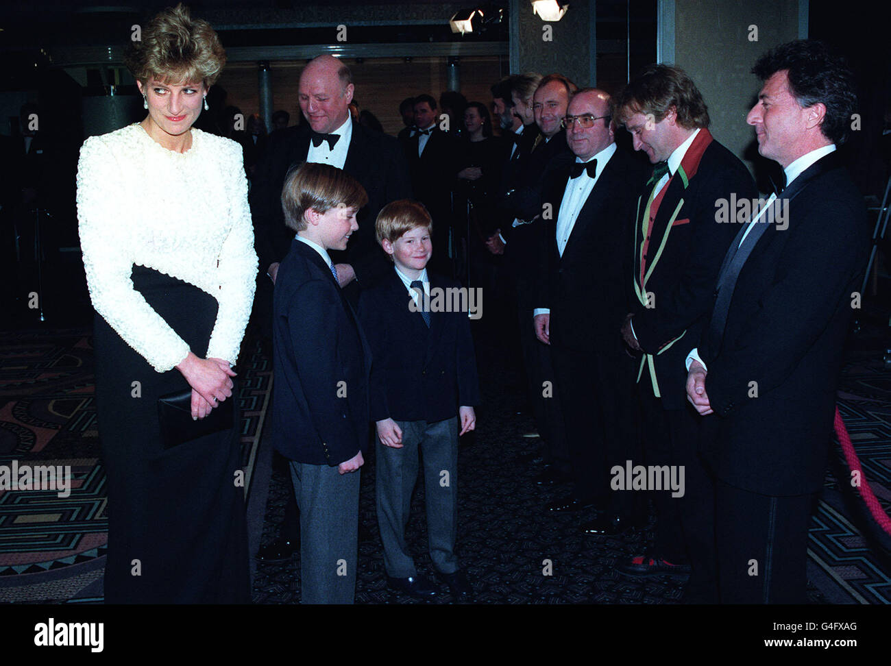 PA NEWS PHOTO 7/4/92 THE PRINCESS OF WALES AND HER TWO SONS, PRINCES WILLIAM (LEFT) AND HARRY, MEET SOME OF THE STARS OF STEVEN SPEILBERG'S LATEST FILM 'HOOK' AT THE ODEON, LEICESTER SQUARE. STARS ATTENDING THE ROYAL PREMIERE INCLUDED (FROM RIGHT) DUSTIN HOFFMAN, ROBIN WILLIAMS, BOB HOSKINS AND PHIL COLLINS. Stock Photo