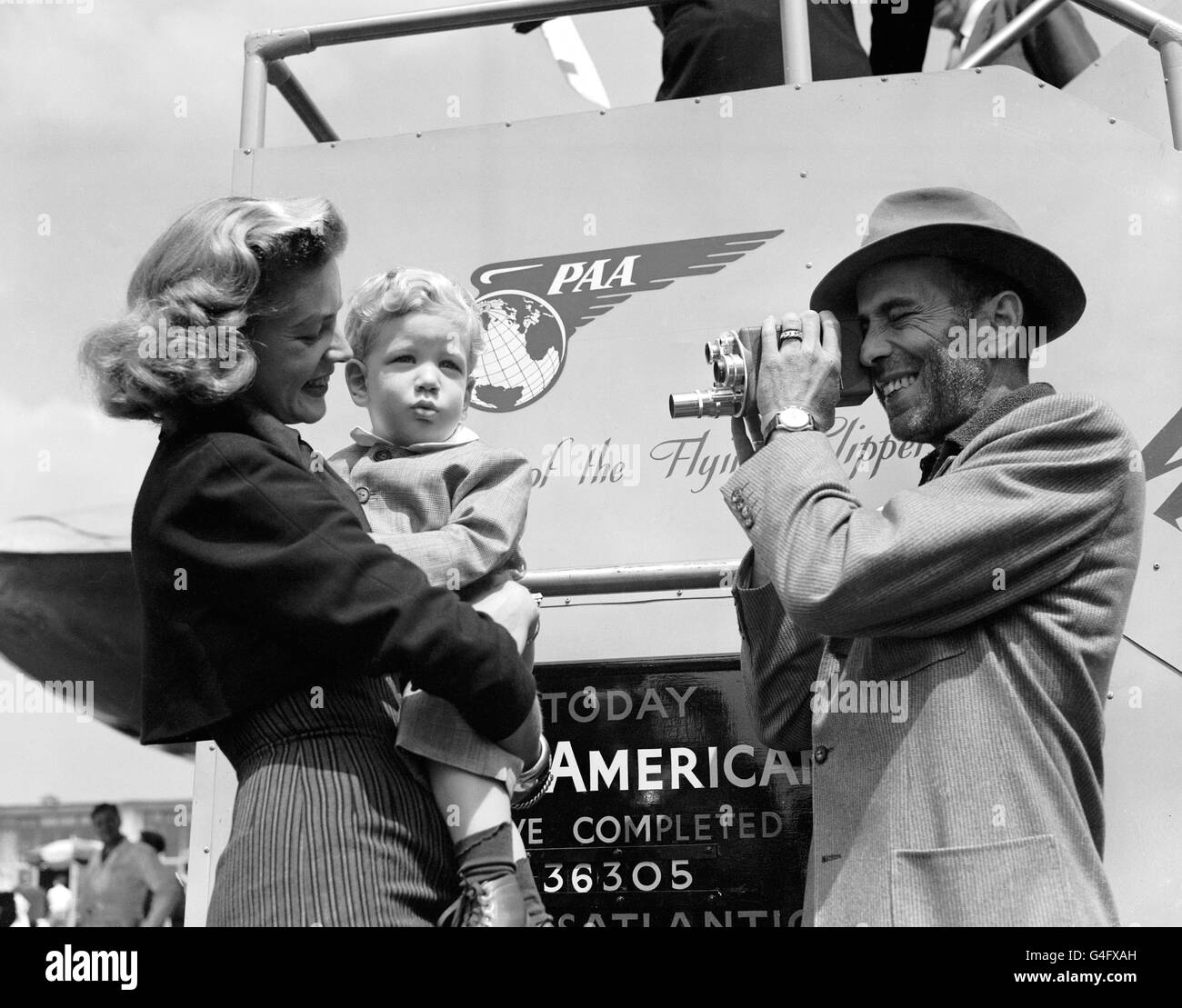 American actor Humphrey Bogart films his wife Lauren Bacall and their son Stephen at London Airport after arriving from New York Stock Photo