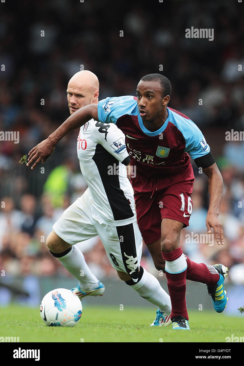Aston Villa's Fabian Delph (right) gets away from Fulham's Andrew Johnson Stock Photo