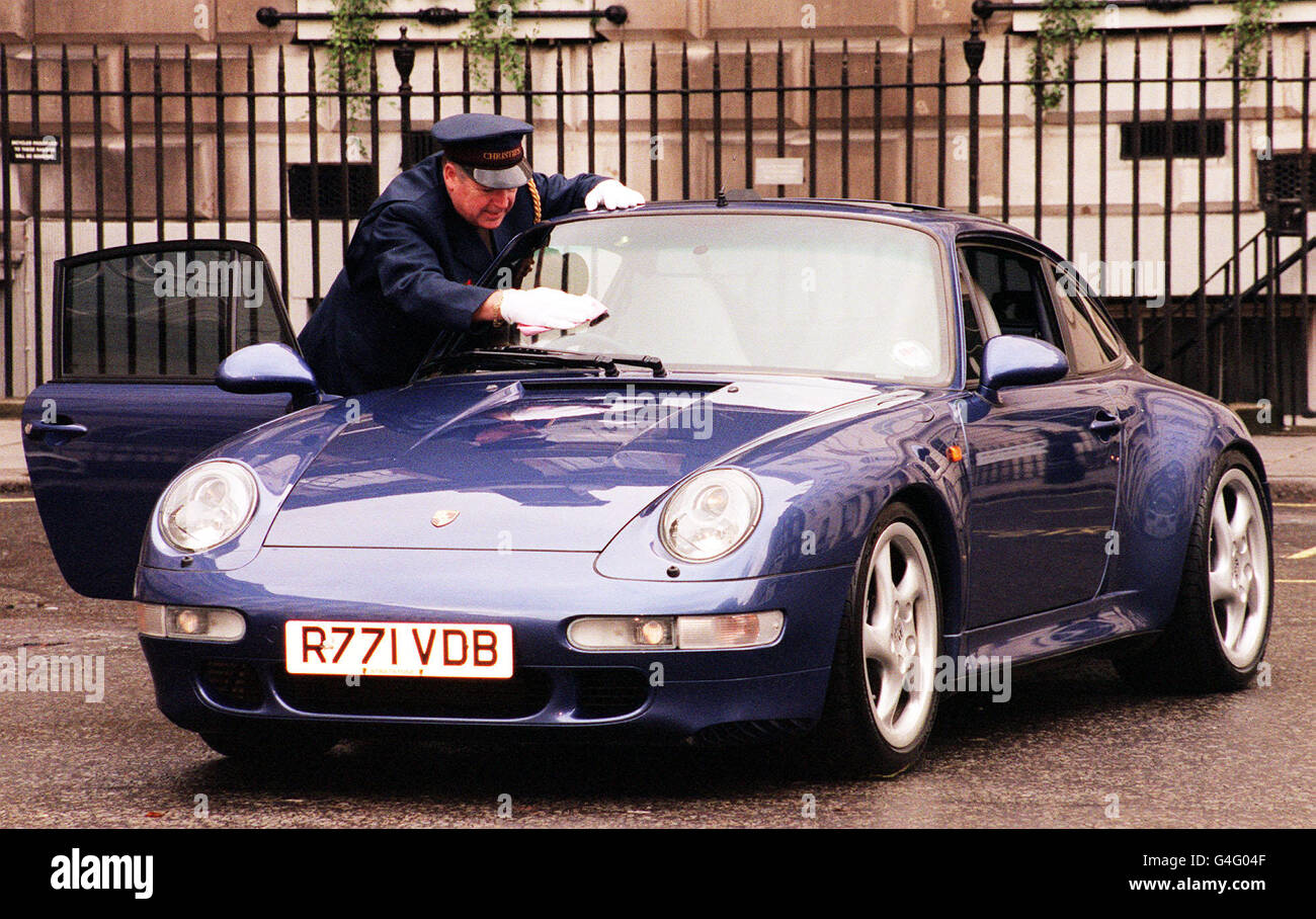 Christie's Security Guard Tom Cartwright adds a bit of sparkle to footballer David Beckham and Spice Girl Victoria Adams' Porsche 911 Carrera. Stock Photo