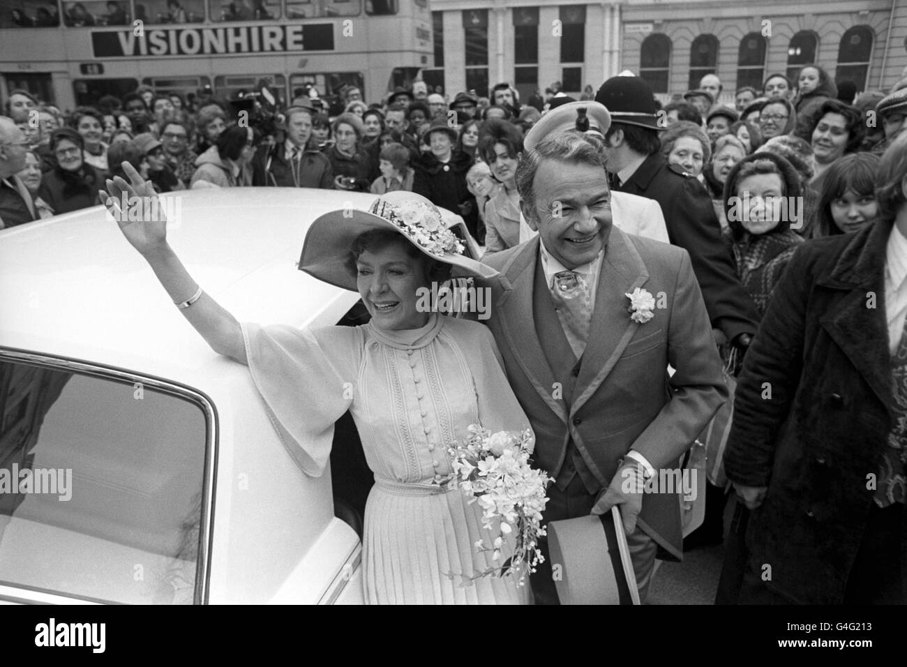 Fans of Crossroads watch two of the stars Noele Gordon (Meg Richardson), left, and John Bentley (Hugh Mortimer), arrive at Birmingham Cathedral for the filming of a service of a blessing for their 'marriage'. Stock Photo
