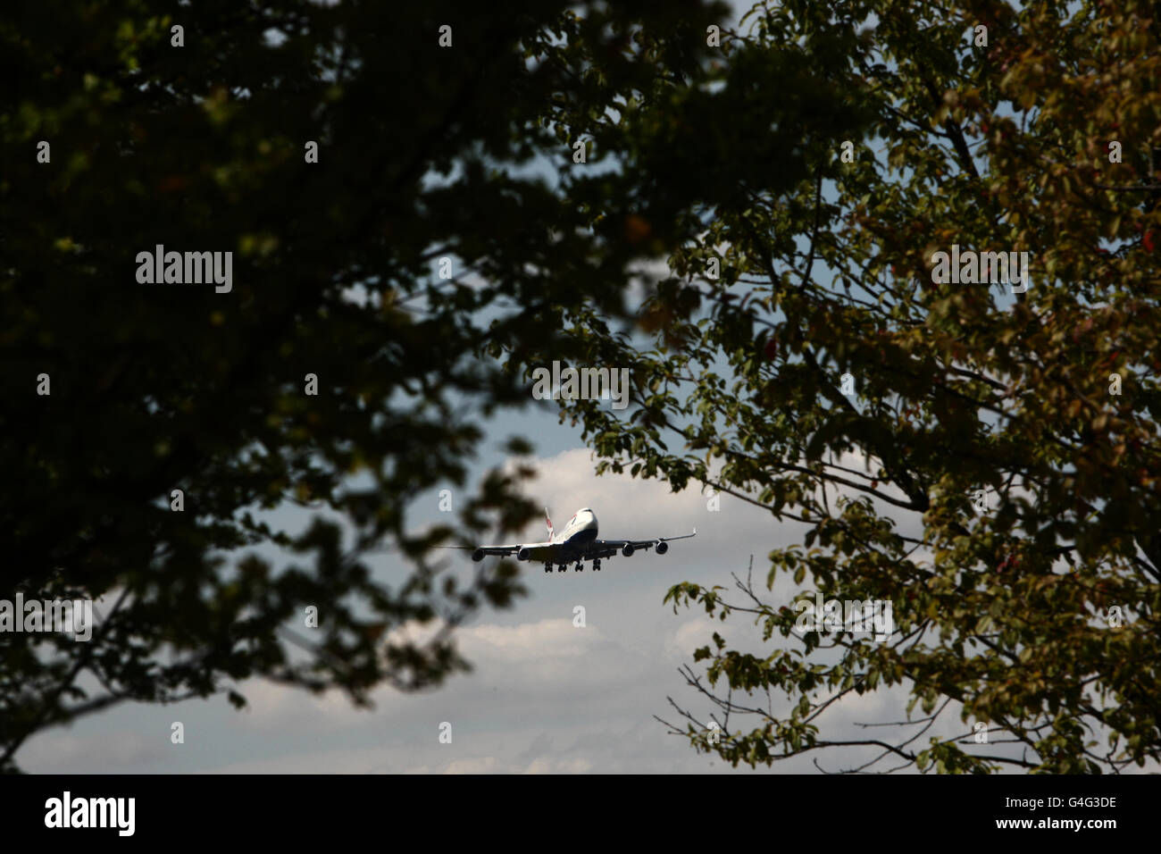 A British Airways plane lands over trees at Heathrow Airport in West London PRESS ASSOCIATION Photo. Picture date: Monday August 22, 2011 See PA story . Photo credit should read: Steve Parsons/PA Wire Stock Photo