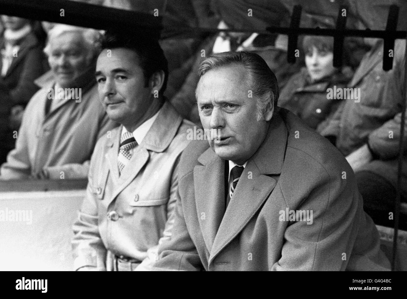 Brian Clough, left, manager of League leaders Nottingham Forest, and assistant manager Peter Taylor watching their men in action against Leeds United at Elland Road, the ground where Clough once had a brief and stormy reign as manager. Stock Photo