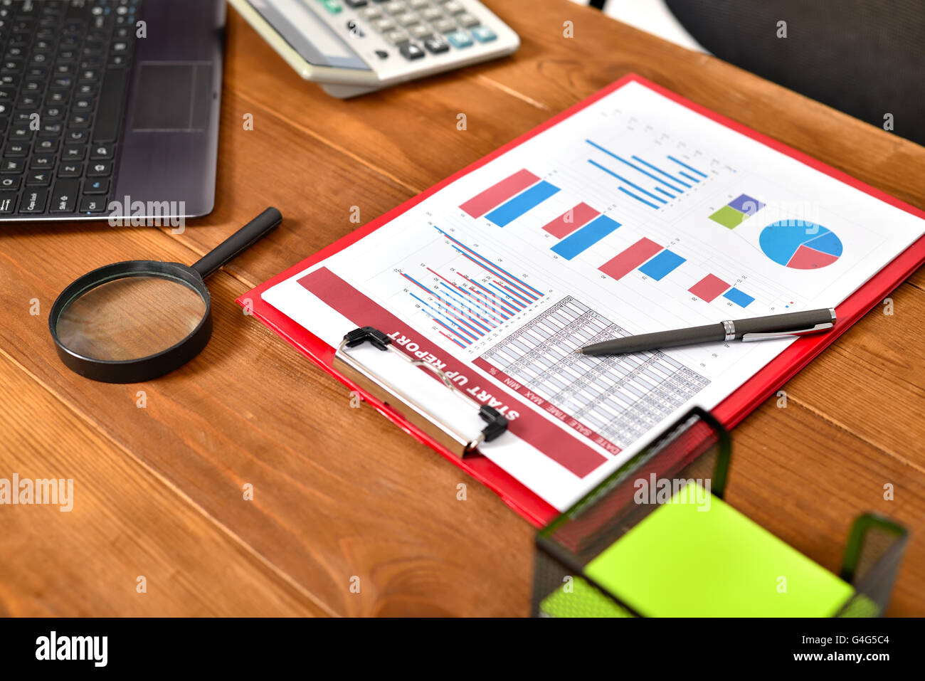 Start up report with chart and tables on wooden table Stock Photo Alamy